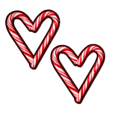 Red and white glitter velvet heart-shaped pasties with candy cane stripe design on white background