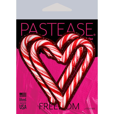 Red and white candy cane heart-shaped nipple pasties on pink and black Pastease packaging, latex-free and made in USA.