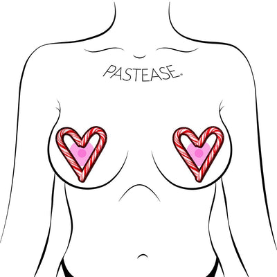 Illustration of red and white candy cane heart-shaped nipple pasties on a stylized female chest outline.