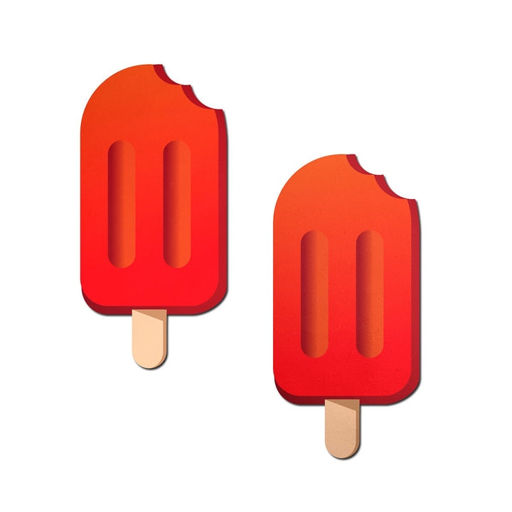 Cherry red popsicle-shaped nipple pasties with a bite detail and wooden stick design, set of two on white background.