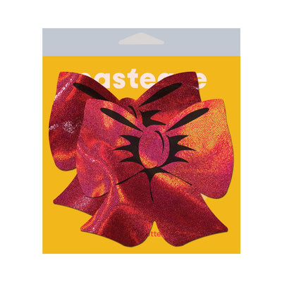 Red holographic bow shaped fuller coverage pasties on yellow Pastease packaging