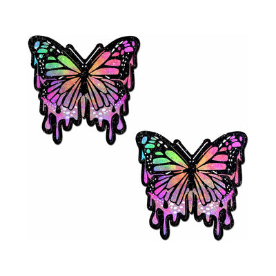 Pair of rainbow glitter butterfly-shaped nipple pasties with a dripping paint design on a white background.