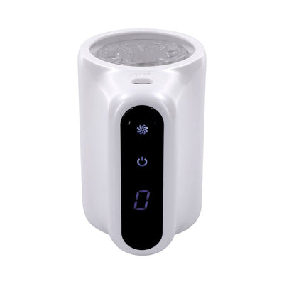 White and clear compact personal massager with digital control panel and spinning inner texture visible from top view.