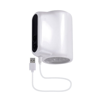 White and black compact spinning pleasure device with USB charging cable and control buttons on the side.