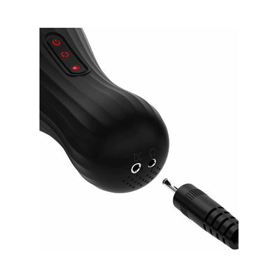 Close-up of the black PDX ELITE Talk Dirty Rotobator showing control buttons and audio and charging ports with a plug nearby.