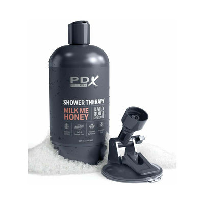 Black PDX Plus Shower Therapy Milk Me Honey Tan bottle with suction cup mount on white foam background
