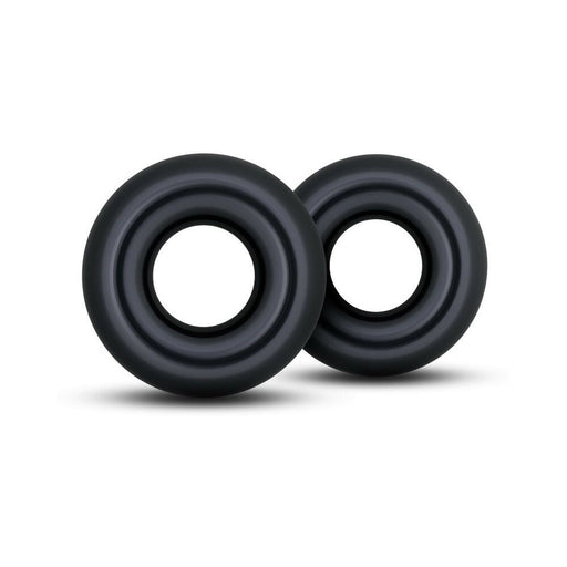 Two oversized black Stay Hard Donut Rings made of stretchy elastomer, shown on a white background.