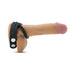 Black silicone cock and ball strap with three snap closures displayed on a realistic male anatomy model.