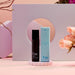 Personal Fav Whet plant-based sex serum bottle and blue packaging displayed with soft pink roses and modern decor background.