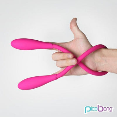 Flexible pink double-ended silicone vibrator held in hand showcasing its bendable design and smooth texture.