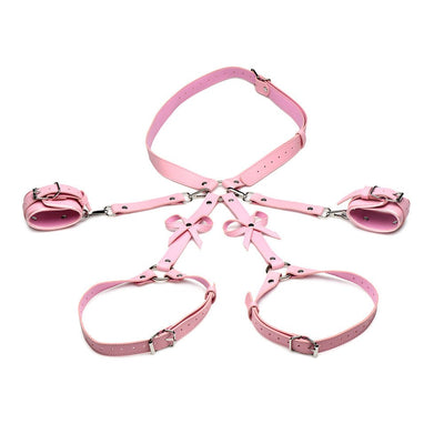 Pink adjustable thigh and wrist bondage harness with decorative bows, made of vegan faux leather.