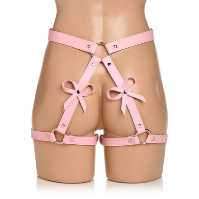Pink faux leather bondage thigh harness with adjustable straps and decorative bows on a mannequin.