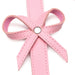 Close-up of pink faux leather bow detail on bondage thigh harness strap with silver rivet center.