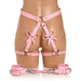 Pink faux leather bondage thigh harness with bows and matching wrist cuffs displayed on a mannequin.