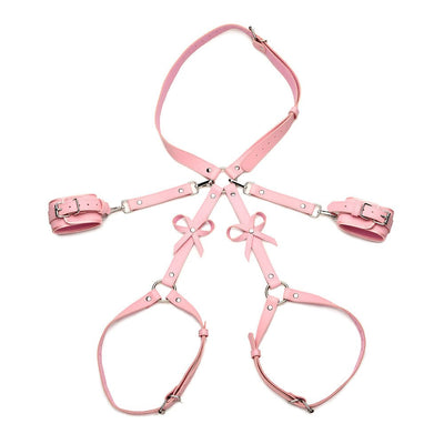 Pink adjustable bondage thigh harness with bows, wrist cuffs, and waist strap made of vegan PU leather.