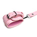 Pink adjustable faux leather wrist cuff with silver buckle and attached strap on white background.