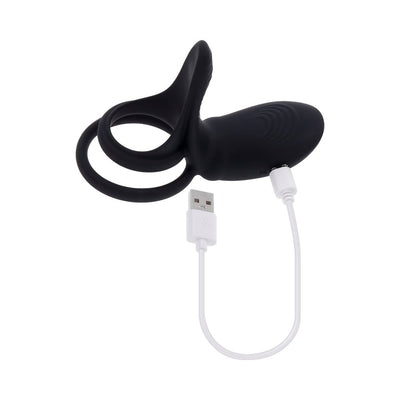 Black rechargeable silicone C-ring with dual stretchy rings and USB charging cable on white background