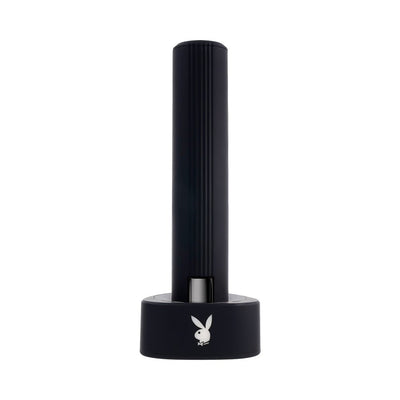Sleek black Playboy Pleasure Zone 2AM vibrator standing upright in its charging base with illuminated rabbit logo.