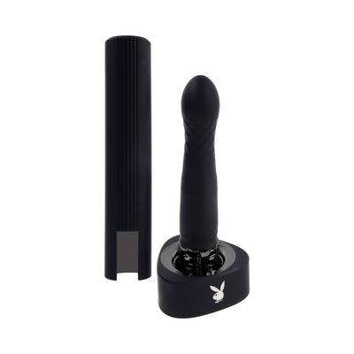 Black Playboy Pleasure Zone 2AM vibrator with textured head, standing in a charging base with a removable protective case beside it.