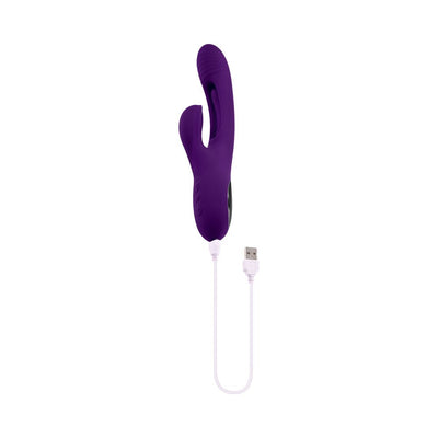 Purple rechargeable silicone dual stim vibrator with mid-shaft flapper and USB charging cable on white background.