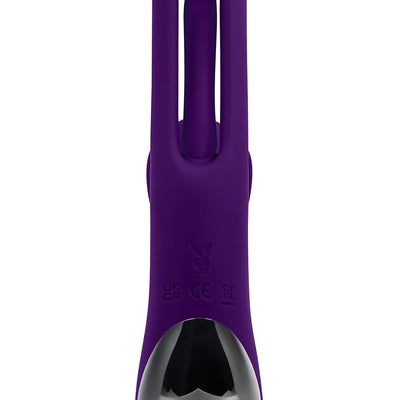 Close-up of purple silicone dual stim vibrator with flapper and Playboy logo on the handle.