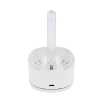 Playboy Twist & Stroke Frost stroker in white charging and UV cleaning dock on a white background.