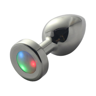 Small metal anal plug with a smooth, polished finish and multicolor LED light-up base.