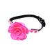 Pink silicone flower-shaped ball gag with adjustable black strap and gold-tone hardware on white background