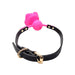 Pink silicone flower ball gag with black adjustable strap and gold-tone buckle on white background.