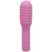 Pink rechargeable mini massager with textured removable silicone sleeve and power button on handle.