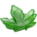 Green translucent plastic ashtray shaped like a stylized leaf with multiple grooves for resting smoking items.