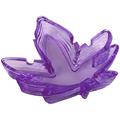 Purple glass ashtray shaped like a stylized leaf with multiple grooves and notches for resting items.