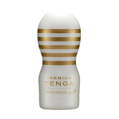 White and gold Premium Tenga Original Vacuum Cup Gentle with horizontal stripes and elegant branding.