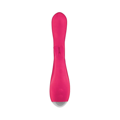 Pink silicone dual stimulator with bunny ear detail and ergonomic shape on white background.