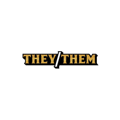 They/Them pronoun enamel pin with gold glitter lettering and black outline on white background
