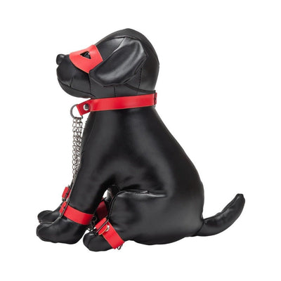 Black leather dog-shaped model wearing red collar, cuffs, chains, and eye mask for fetish play accessory display.