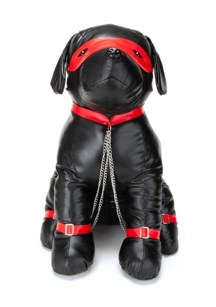 Black leather dog-shaped cushion with red collar, eye mask, leg straps, and attached silver chains.