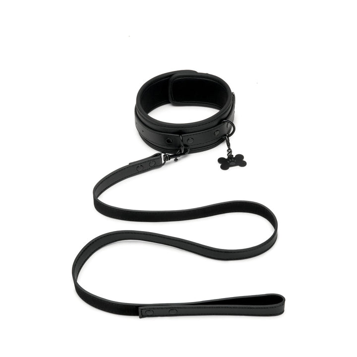 Black faux leather collar and leash set with adjustable buckle and bone-shaped charm on collar.