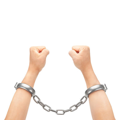 Hands wearing silver heavy-duty linked handcuffs against a white background.