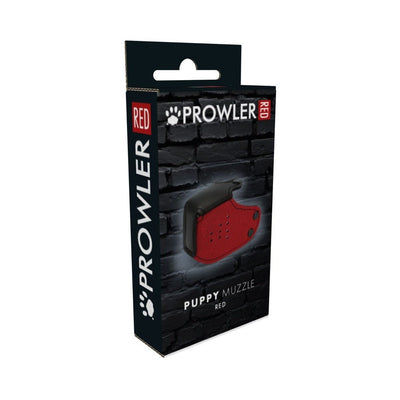 Packaging box of Prowler Red Puppy Muzzle with black and red design against a dark brick background.