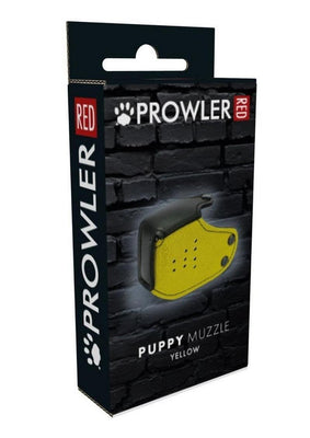 Packaging box for Prowler Red Puppy Muzzle in yellow with black accents against a dark brick background.