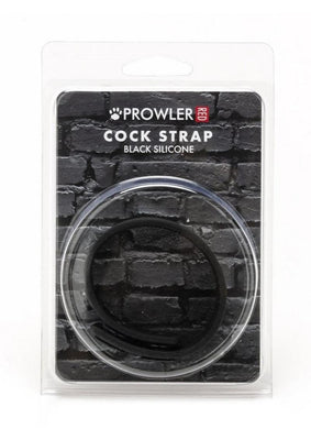 Prowler Red Silicone Cock Strap in black, packaged on a black brick background in clear plastic case.