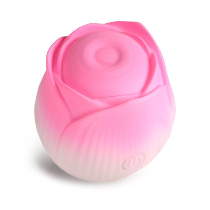 Pink rose-shaped pulsing stimulator made of smooth silicone with a subtle gradient and a power button on the side.