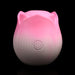 Pink and white rose-shaped pulsing stimulator with power button on front, made of smooth silicone.