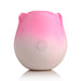 Pink and white rose-shaped pulsing stimulator with power button on front, made of smooth silicone.