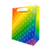 Rainbow gradient gift bag with white ribbon handles and small white leaf pattern design