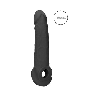 Black realistic penis extender with textured surface and integrated ring, labeled renewed, on white background.