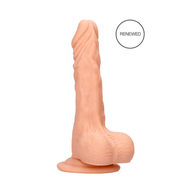 Vanilla-colored realistic dildo with detailed texture and attached balls on a suction base, standing upright on white background.