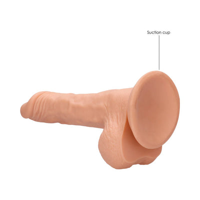 Vanilla-colored realistic dildo with textured shaft, hanging balls, and strong suction cup base on white background.