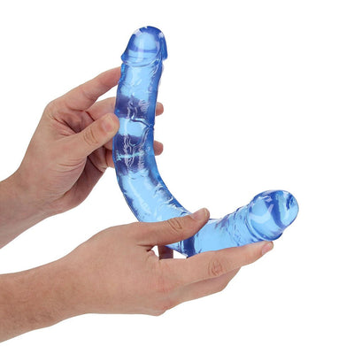 Hands holding a flexible blue crystal clear double-ended dildo with realistic texture and shape.